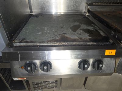 une photo d'une cuisinière à gaz professionnelle dans une cuisine professionnelle
