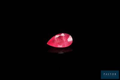 a pink diamond on a black background
