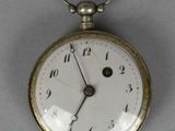 a close up of a pocket watch on a table