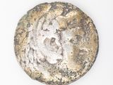 an image of a coin with a face on it