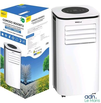 un climatiseur blanc posé à côté d'un carton