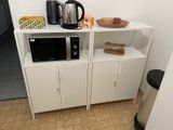 a microwave and a microwave oven in a small room