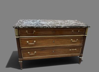 an antique chest of drawers with a marble top and brass handles