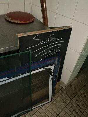 a blackboard with writing on it next to a stove