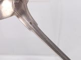 a spoon with a bird head on it sitting on a table