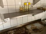 a dirty counter in a dirty kitchen with a lot of bottles on it