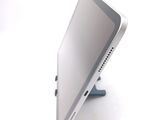 a tablet computer sitting on a stand on a white surface