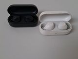 two ear buds in a case sitting on a table