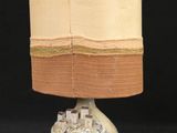 a lamp that is sitting on a table with a black background