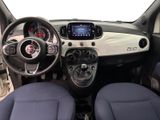 the interior of a small car with a steering wheel and dashboard