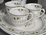 a lot of cups and saucers sitting on a table