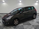 the grey minivan is parked in a room with a checkered floor