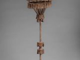 an image of a wooden sculpture of a birdhouse on a pole