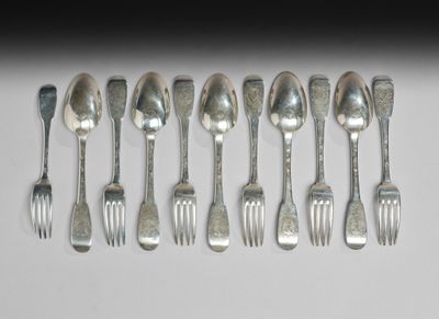 a lot of silver spoons and forks on a table
