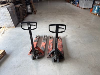 two forklifts that are sitting in a warehouse