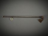 a close up of a metal object on a wall with an axe