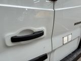 a close up of a door handle on a white truck
