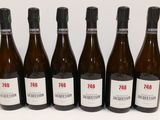 six bottles of wine are lined up in a row on a table
