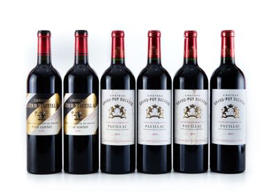 six bottles of red wine lined up in a row on a white surface