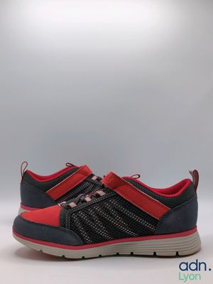 a close up of a pair of black and red shoes