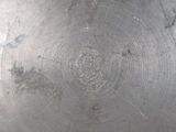 a close up of a metal plate with a circular design