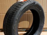 tire on the floor next to a cardboard box with a cardboard box in the background