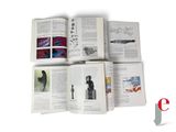 a lot of books that are open on a white surface