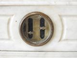 a close up of a clock on the side of a white refrigerator
