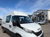 the white van is parked in a parking lot with other cars