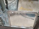 a silver tray with a mirror on it in a store window