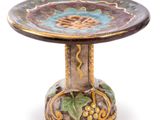 a small decorative table with a flower on it