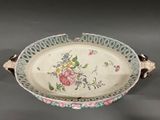 a large white bowl with a floral design on it