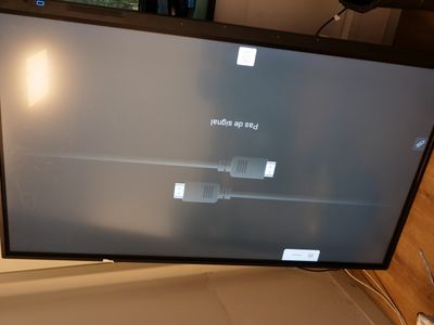 a flat screen tv sitting on top of a desk