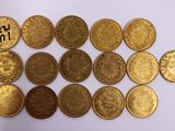 a bunch of gold coins sitting on top of a white surface