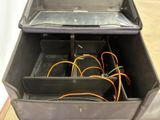a black box with wires in it on the floor