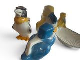 three figurines of birds sitting next to each other