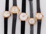 four different types of watches are lined up on a white surface