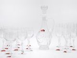 many wine glasses and a decanter on the table