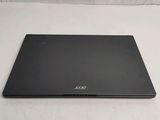 the back of a black laptop computer sitting on top of a white surface