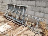 a broken bench on the ground next to a wall