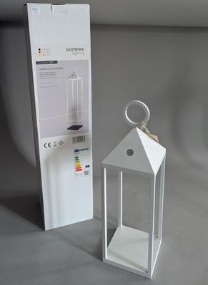 a white lantern that is next to a white box
