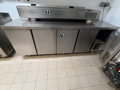 a large stainless steel kitchen with a dishwasher and a dishwasher