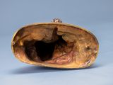 a gold purse that is sitting on a blue surface