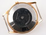 a close up of a wrist watch on a white surface