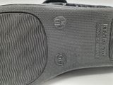the bottom of a pair of gray shoes with black soles