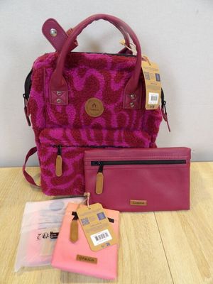 pink purse and wallet sitting on top of a table next to a pink purse