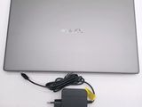 a laptop with a charger attached to it on a table