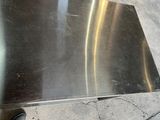 a metal table that has a metal top on it