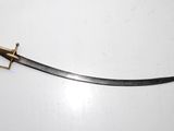 a close up of a sword on a white surface