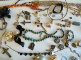 many different types of necklaces and bracelets laid out on a table